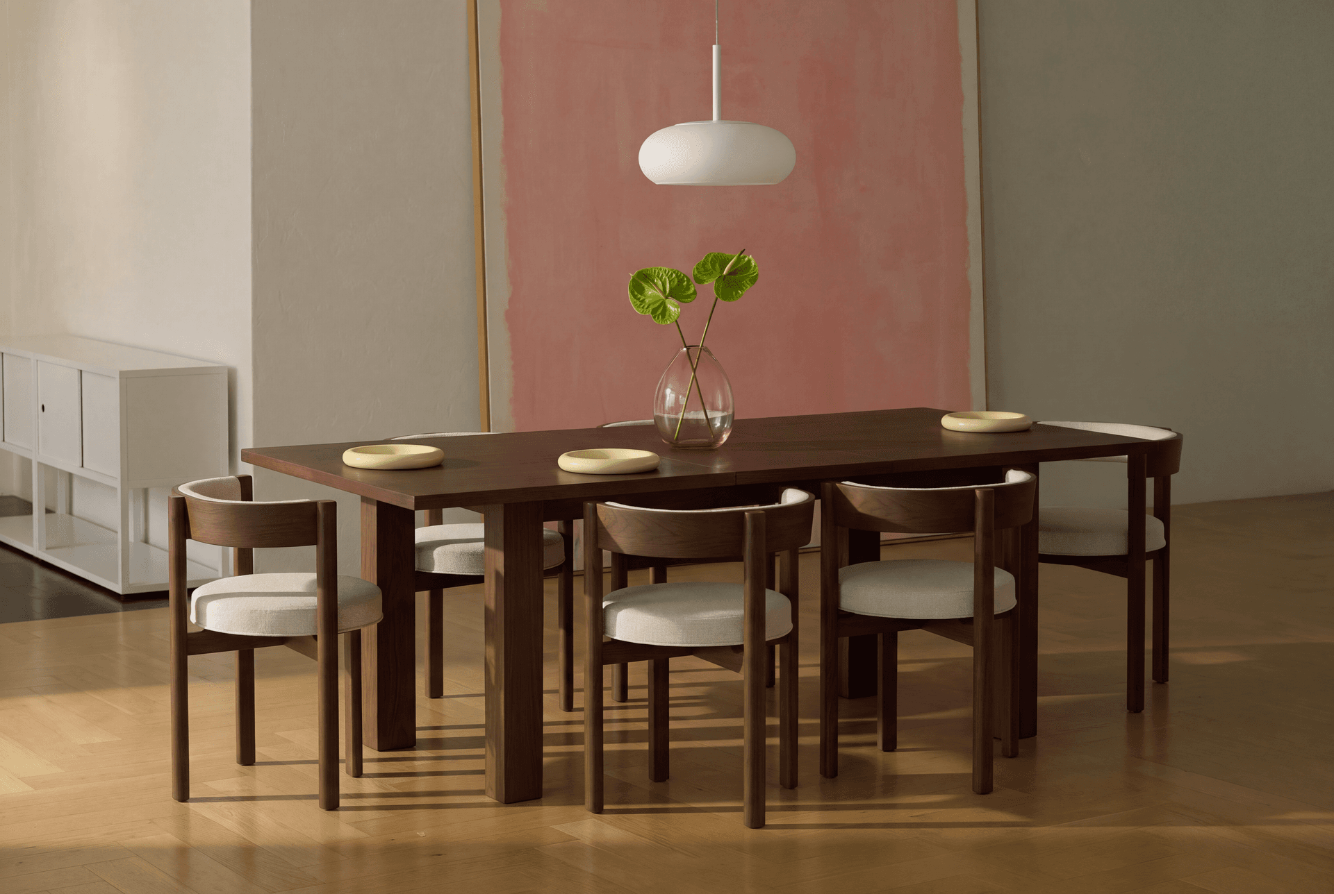 A Cozey Aurbit square dining table extended with six chairs