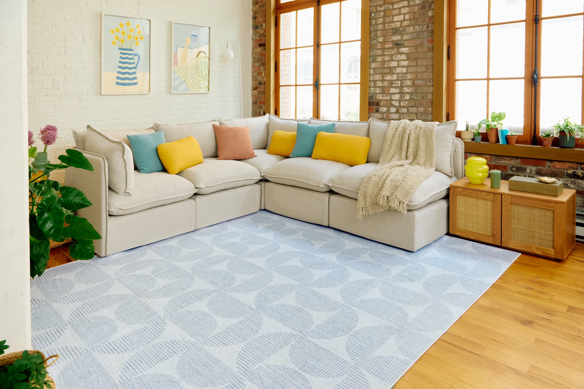 Cozey sectional sofa in a loft living room on a blue patterned washable rug