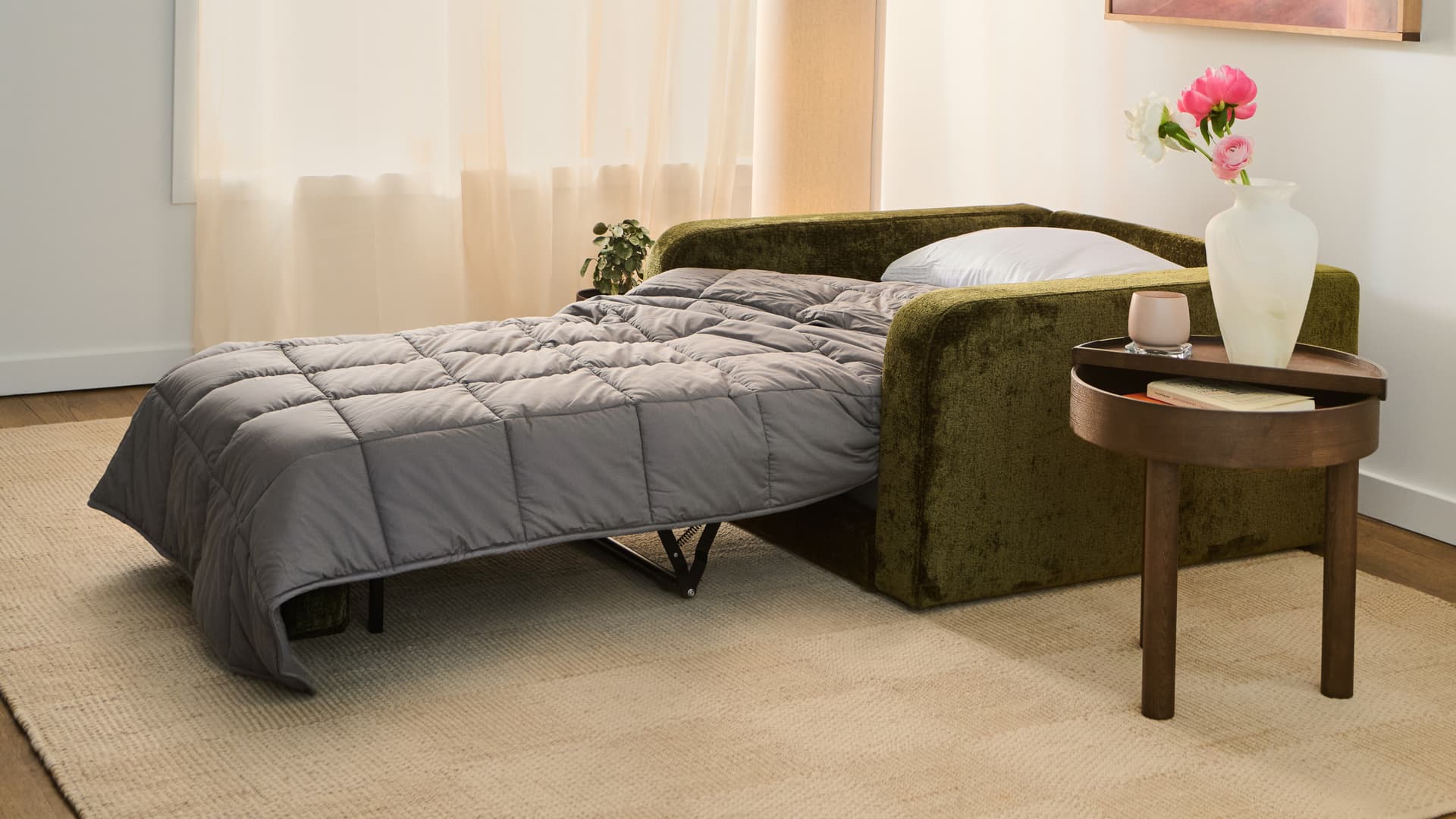 Green Cozey Orian two-seater sofa bed with the sleeper unfolded