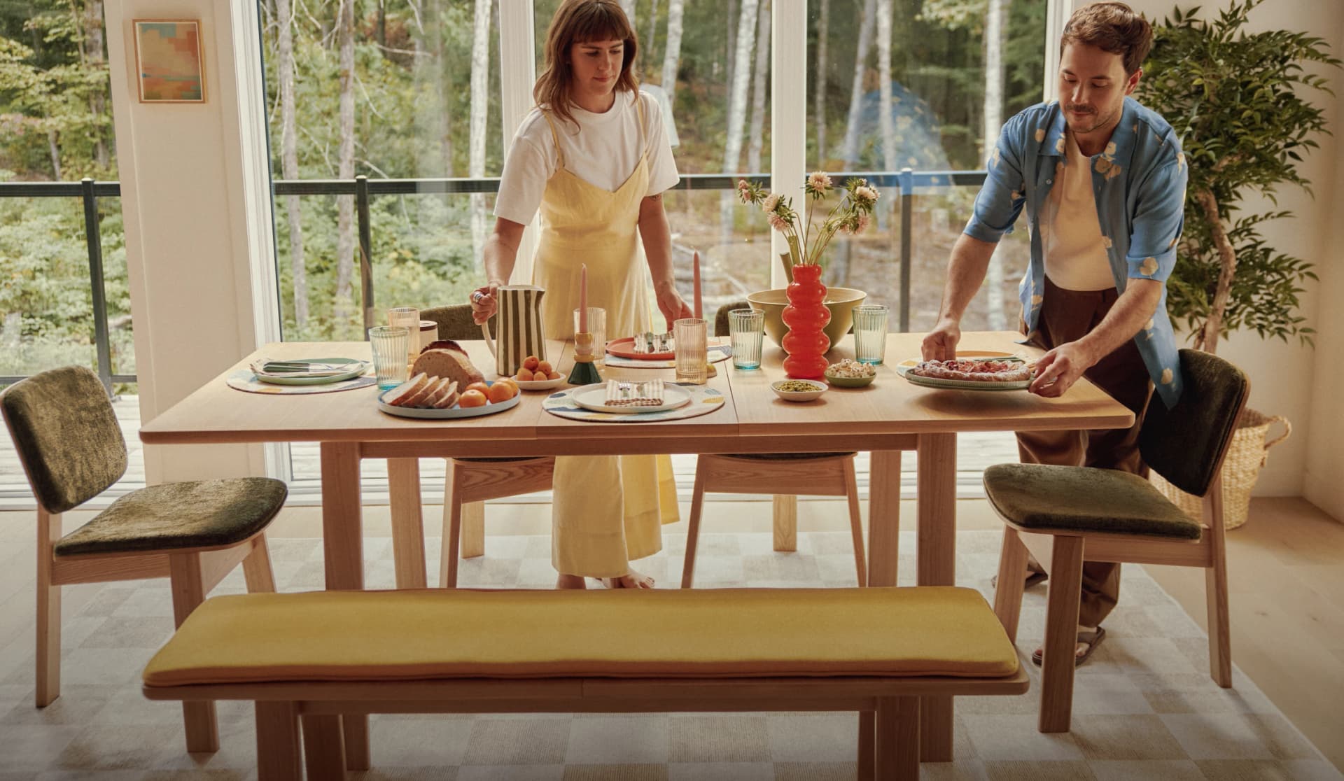 Two people setting a dining table