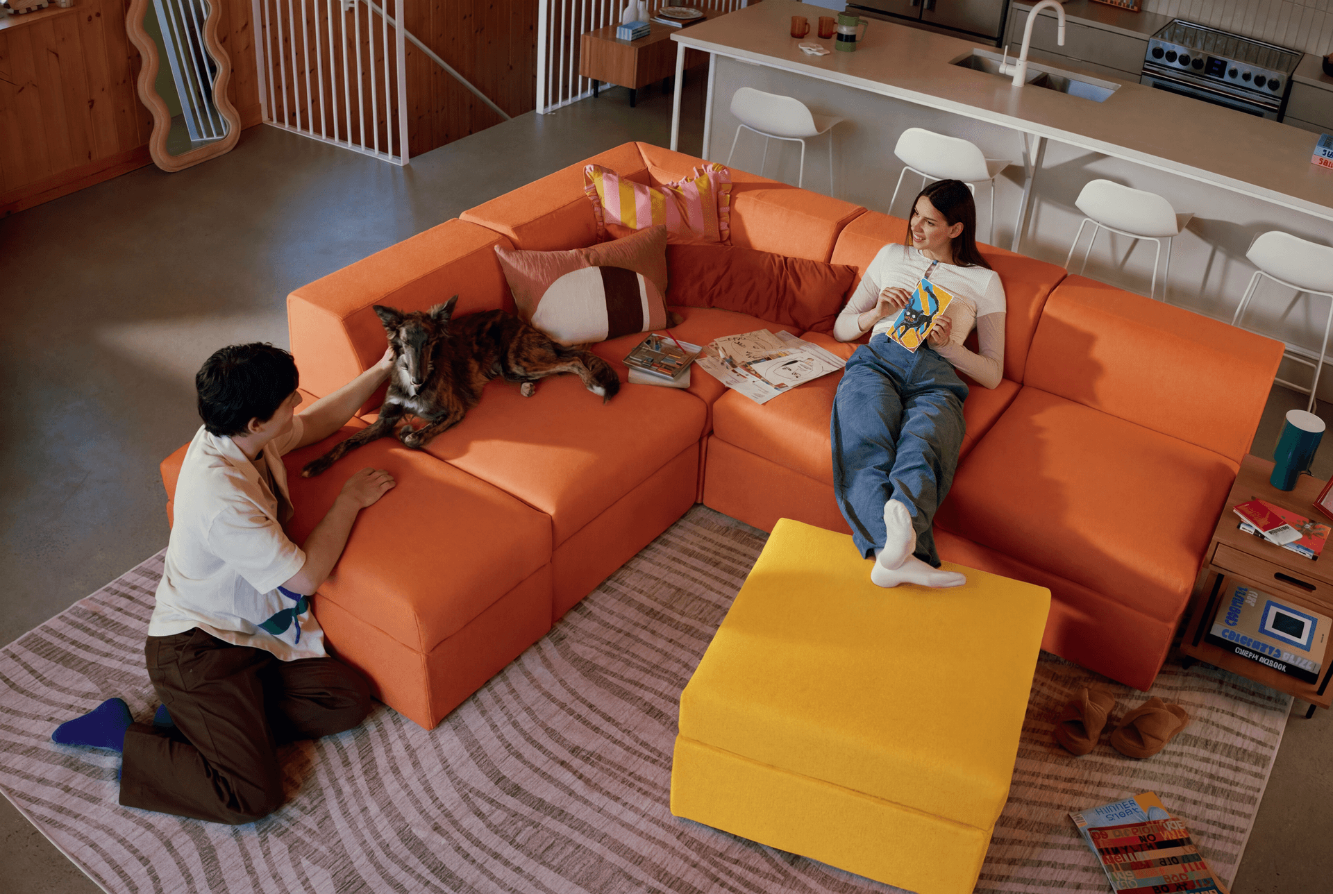 A couple and their dog sitting in their living room