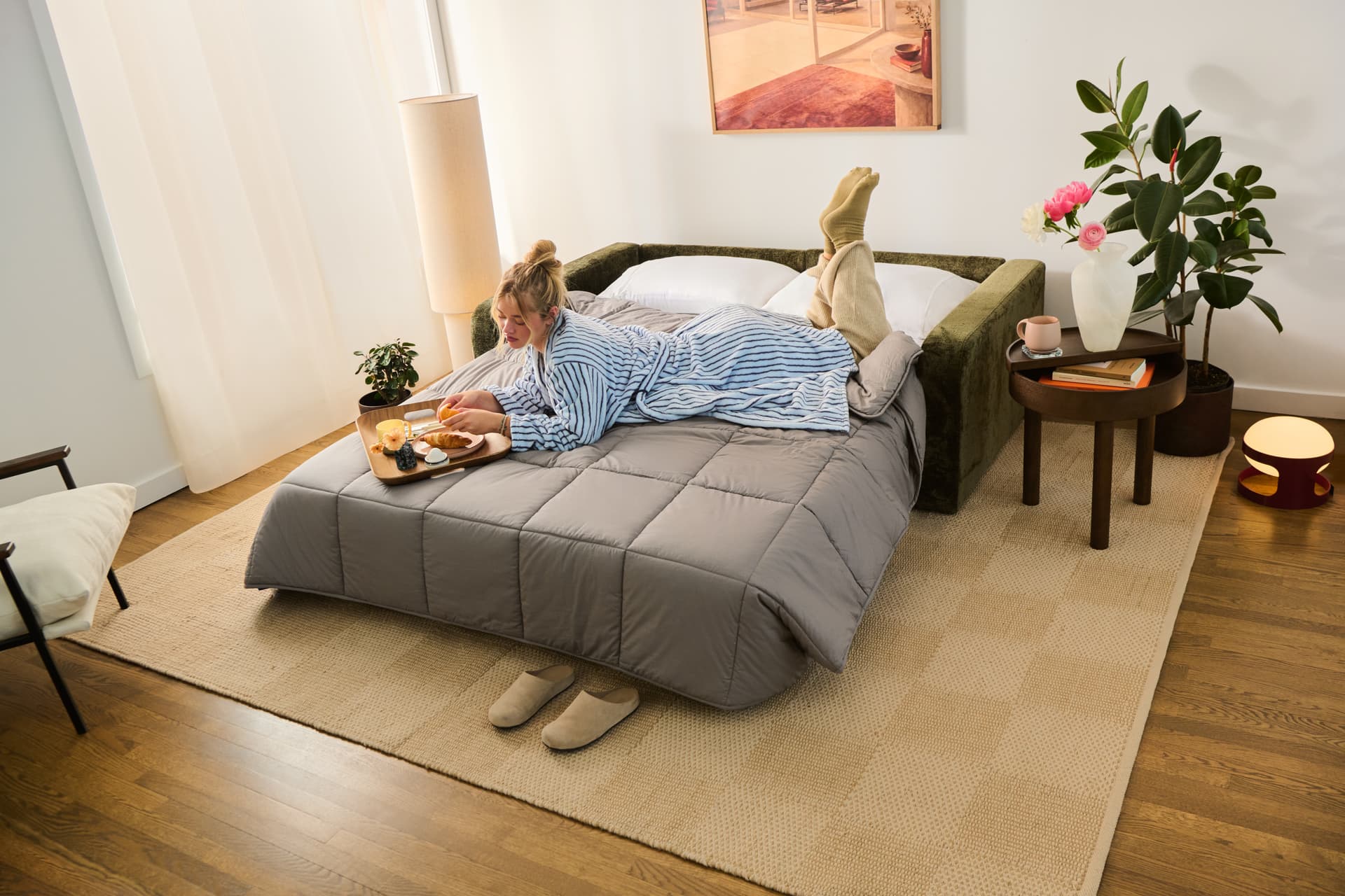 A person lounging on a sofa bed
